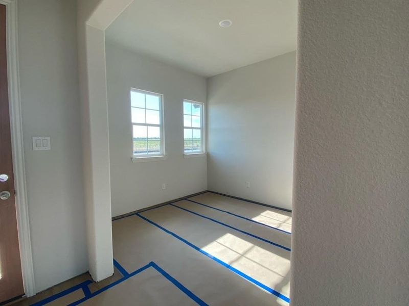 Room featuring two multi-pane windows, recessed ceiling lighting, and light-toned wall finishes
