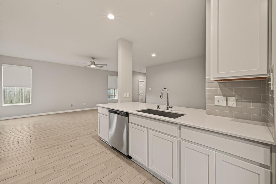 From the kitchen, you have a clear view of the living and dining areas, allowing for easy interaction and a connected feel throughout the main space.