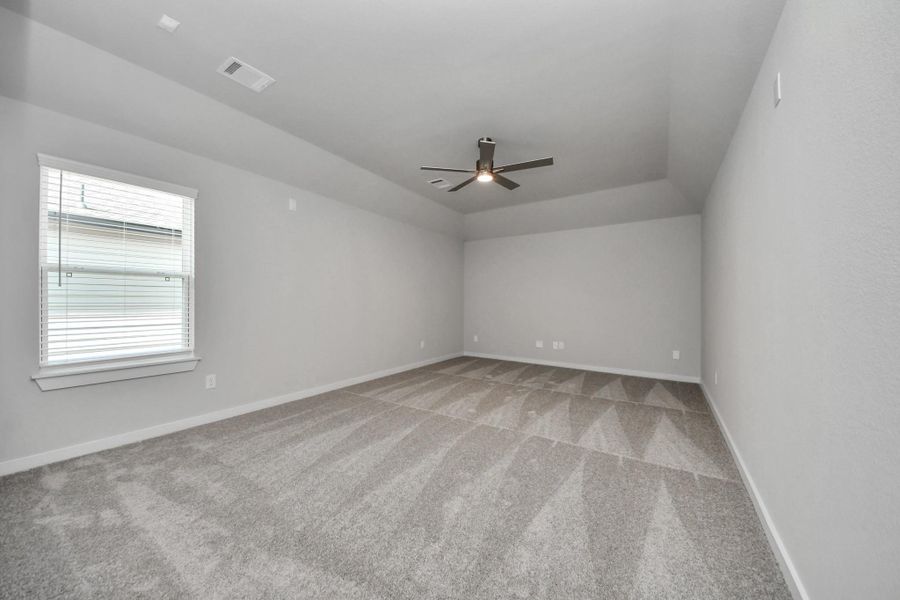 Secondary bedroom features plush carpeting, large windows that let in plenty of natural light, bright paint, and spacious closets.