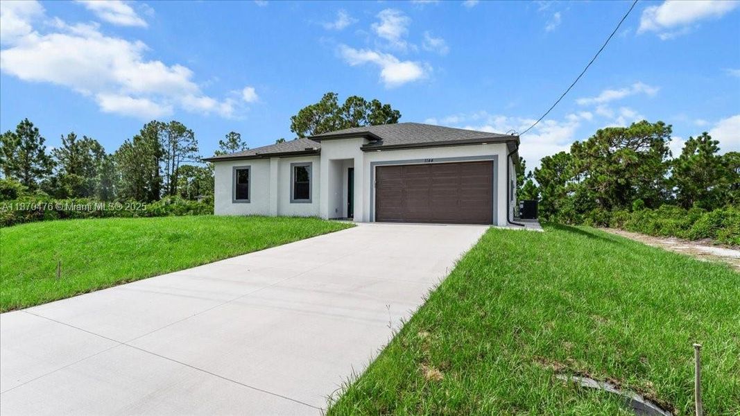 Front exterior of a new home in , Lehigh Acres, FL, highlighting curb appeal (Image 22). Front exterior of a new home in , Lehigh Acres, FL, highlighting curb appeal (Image 22).