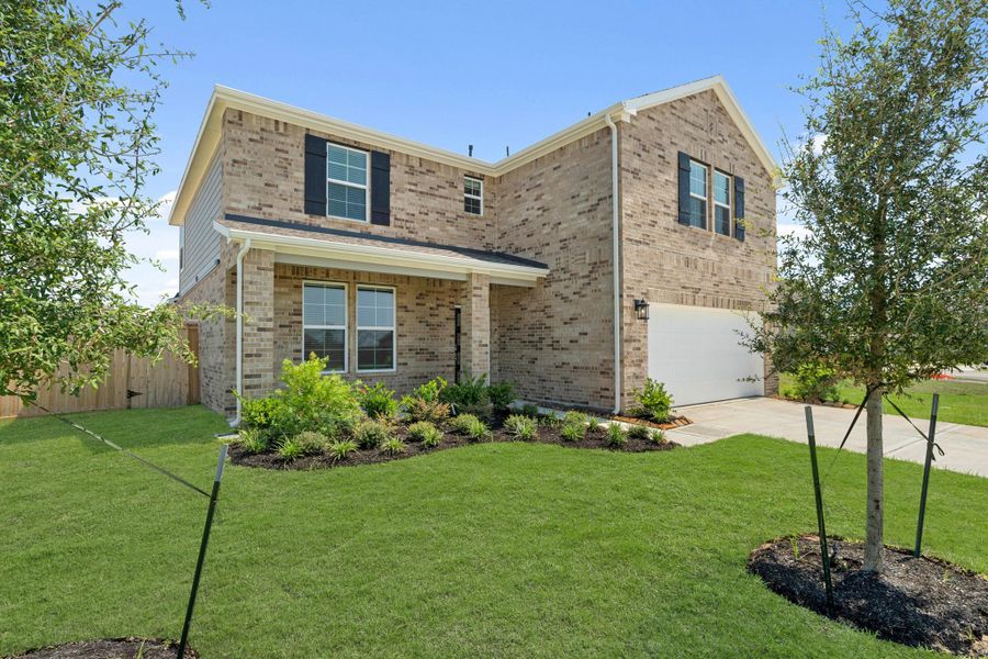 Front exterior of a new home in Sunterra, Katy, TX, highlighting curb appeal (Image 16).