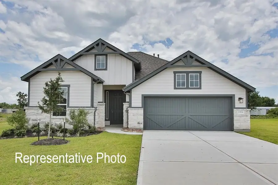 Craftsman-style house featuring a front yard and a garage