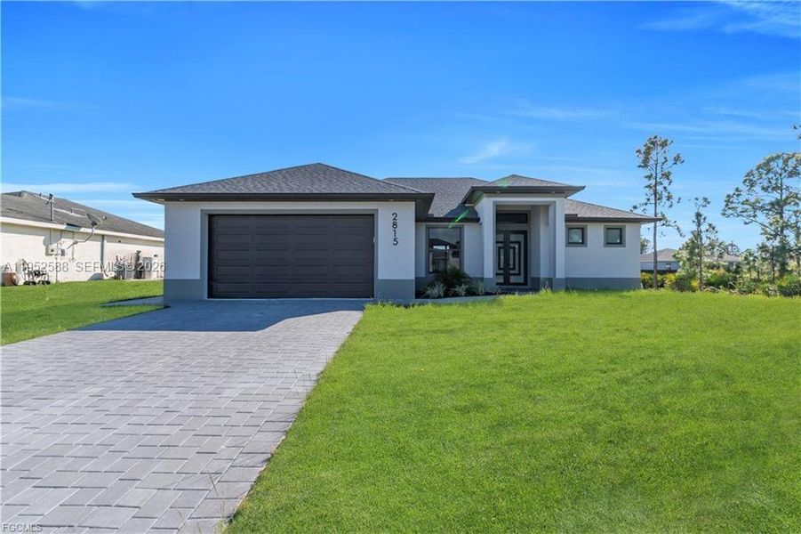 Front exterior of a new home in , Lehigh Acres, FL, highlighting curb appeal (Image 25).