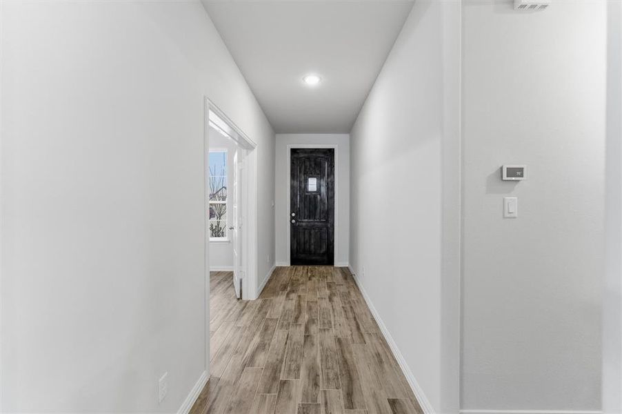 Entryway with baseboards and wood finished floors Entryway with baseboards and wood finished floors