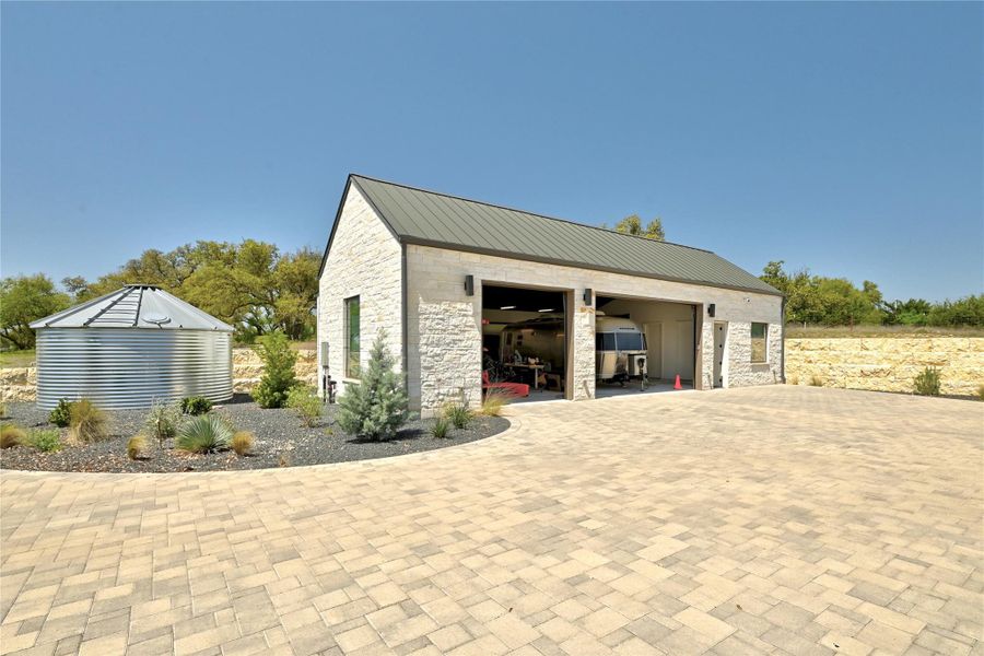 View of patio featuring an outdoor stone fireplace, outdoor dining space, grilling area, and a ceiling fan View of patio featuring an outdoor stone fireplace, outdoor dining space, grilling area, and a ceiling fan