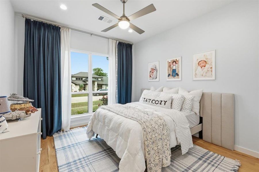 Bedroom with light wood-type flooring, ceiling fan, and recessed lighting
