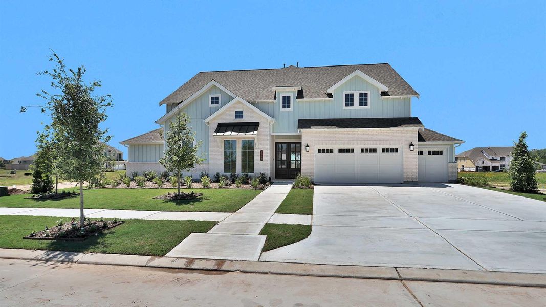 Front exterior of a new home in Fulshear Lakes, Fulshear, TX, highlighting curb appeal (Image 2). Front exterior of a new home in Fulshear Lakes, Fulshear, TX, highlighting curb appeal (Image 2).