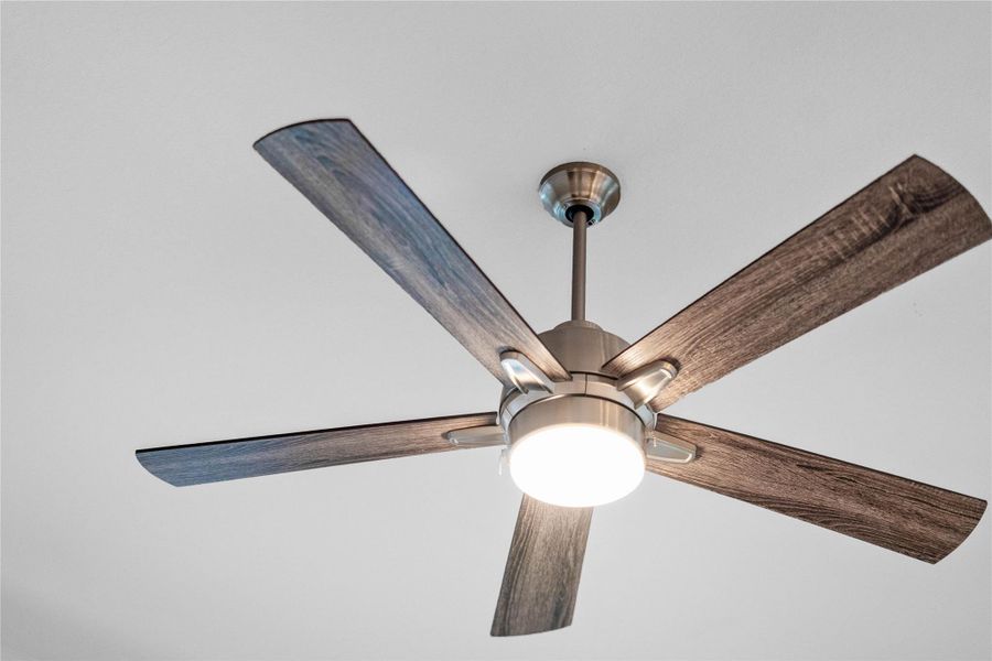 The 52-inch ceiling fan featuring a sleek brushed nickel finish with reversible blades offers a distinct wood-look design.