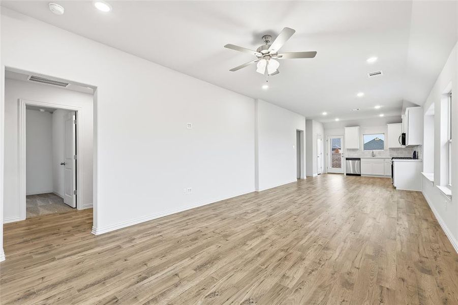 Unfurnished living room featuring recessed lighting, light wood-style flooring, and a ceiling fan