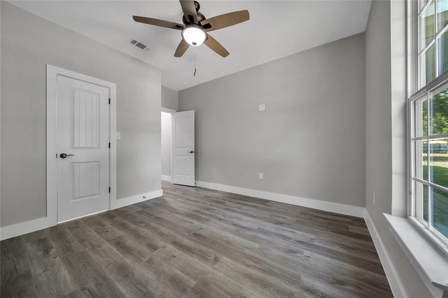 Unfurnished bedroom with hardwood / wood-style floors and ceiling fan