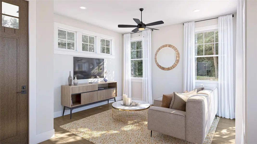 Living area with wood finished floors, a ceiling fan, and recessed lighting Living area with wood finished floors, a ceiling fan, and recessed lighting