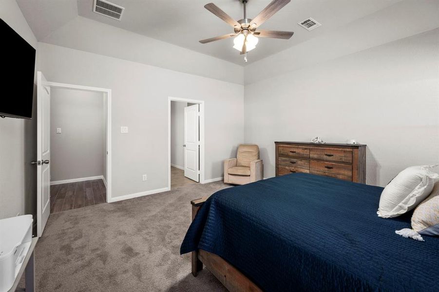 Spacious primary retreat will accommodate large scale furniture. A glimpse of the exquisite en suite bath.