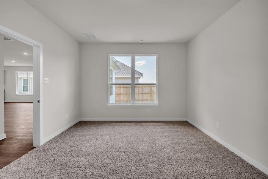 Carpeted empty room featuring healthy amount of natural light Carpeted empty room featuring healthy amount of natural light