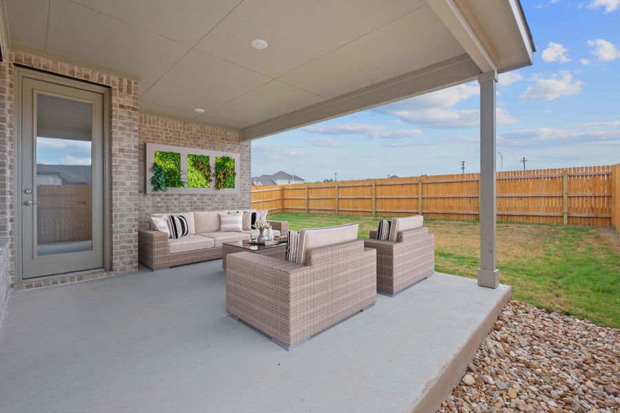 Fenced backyard featuring a patio and an outdoor hangout area Fenced backyard featuring a patio and an outdoor hangout area