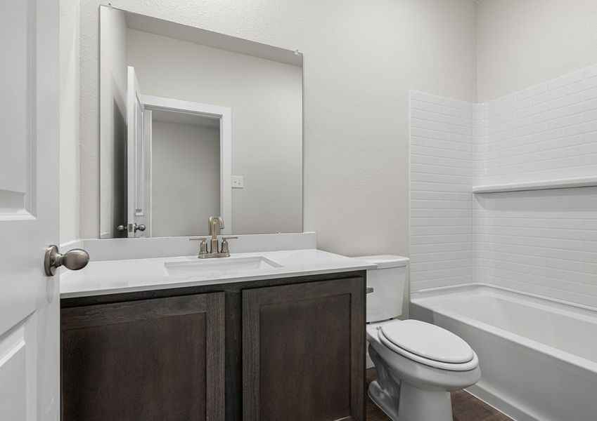 The secondary bathroom has a vanity space and a shower-tub combo.