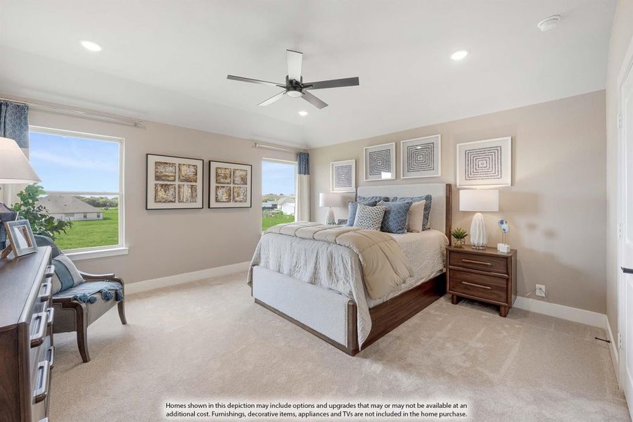 Bedroom with wood-frame bed, ceiling fan, carpet flooring, and large windows with outdoor views