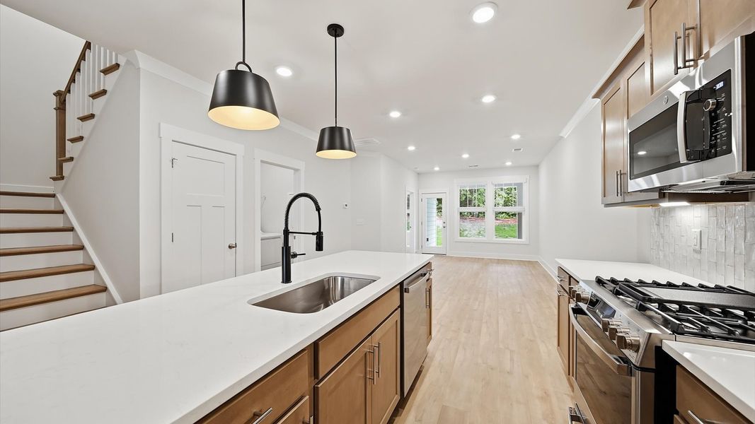Well-designed kitchen with a center island and tasteful finishes that elevate everyday living Well-designed kitchen with a center island and tasteful finishes that elevate everyday living
