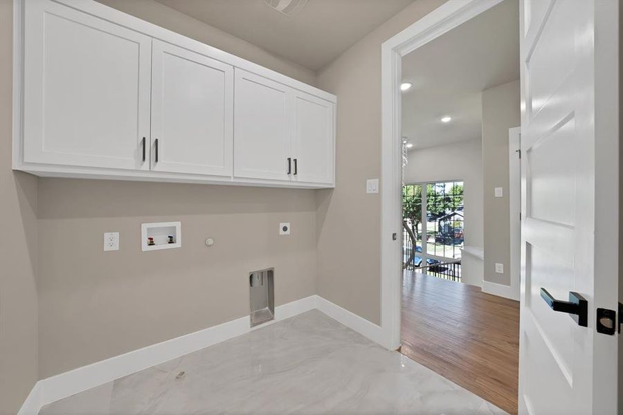 Laundry room with hookup for a gas dryer, hookup for a washing machine, electric dryer hookup, recessed lighting, and cabinet space Laundry room with hookup for a gas dryer, hookup for a washing machine, electric dryer hookup, recessed lighting, and cabinet space