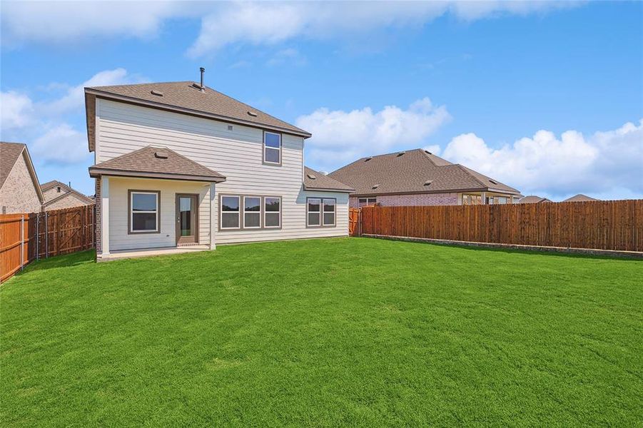 Back of house featuring a yard