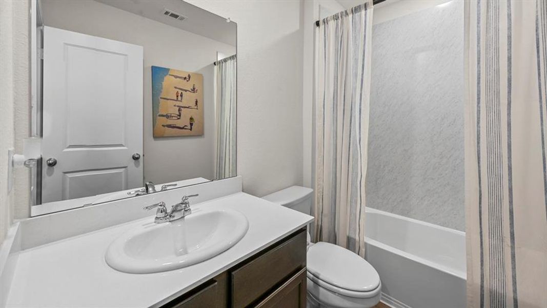 Full bath with vanity and shower / bath combo with shower curtain