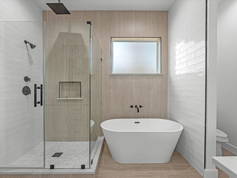 Primary bathroom, freestanding tub, and stand up shower with a glass enclosure. Primary bathroom, freestanding tub, and stand up shower with a glass enclosure.