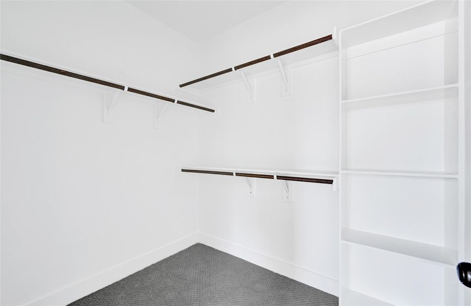 Generous closet with built-in storage and hanging space. Generous closet with built-in storage and hanging space.