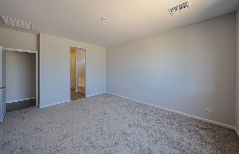A room with carpet and a door. A room with carpet and a door.