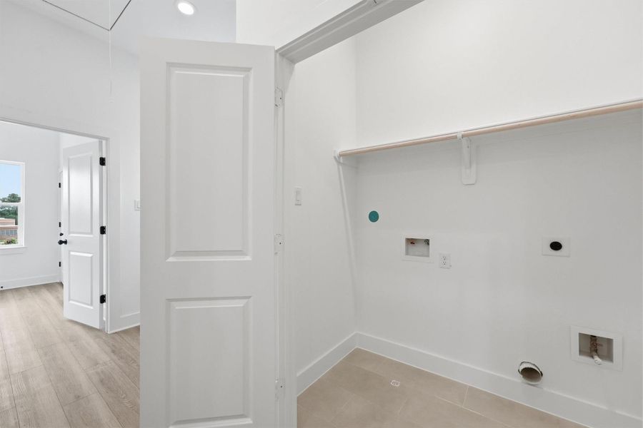 The little things matter too. A dedicated laundry room with full-size washer and dryer connections, gas hookup, tile flooring, and upper shelving puts laundry day exactly where you need it, right next to the bedrooms. The little things matter too. A dedicated laundry room with full-size washer and dryer connections, gas hookup, tile flooring, and upper shelving puts laundry day exactly where you need it, right next to the bedrooms.