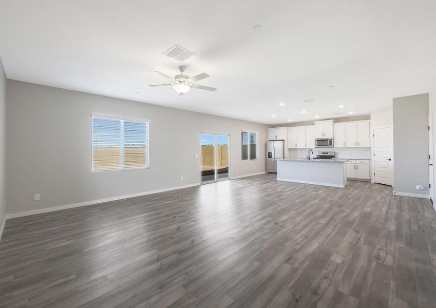 The living room opens up to the dining area and kitchen, creating a seamless layout.