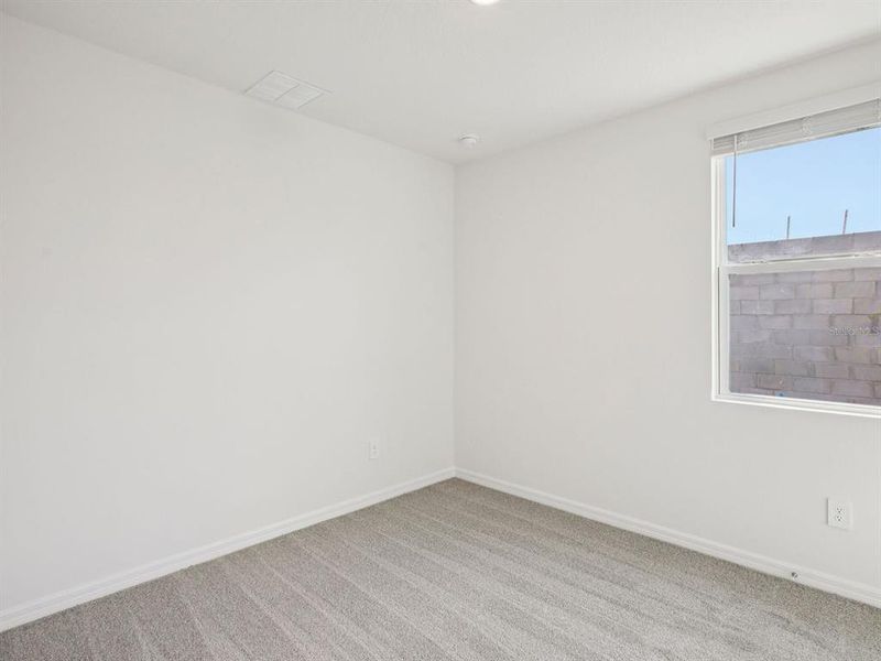 Spacious, unfurnished interior of a new home in The Grove at Stuart Crossing - Premier Series, Bartow (Image 18).