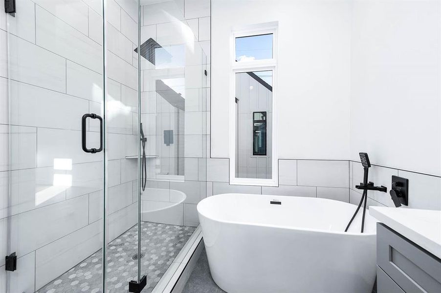 Separate all glass shower next to your soaking tub in the primary bath. Dual vanity.