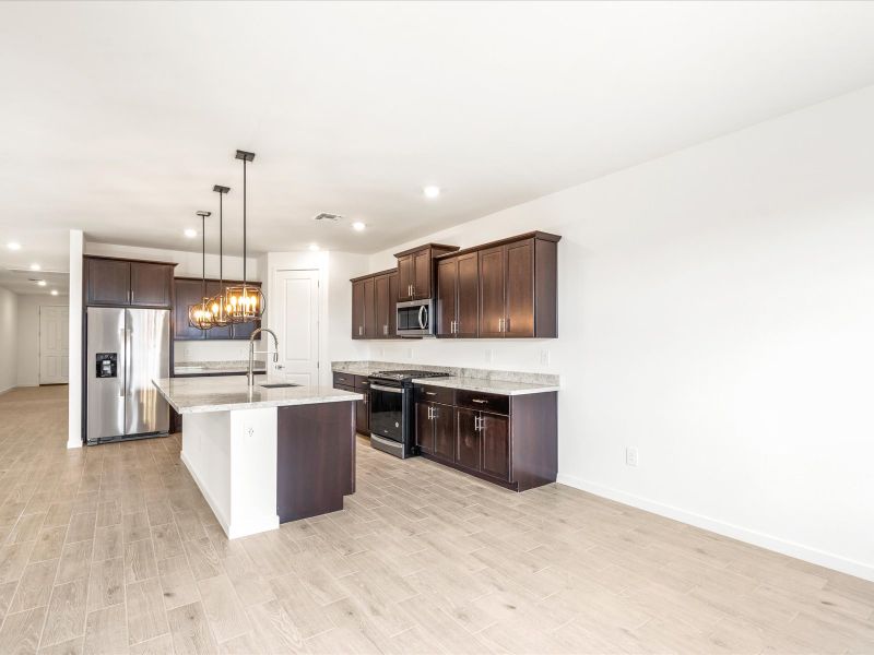 Front exterior of a new home in Rancho Mirage Reserve Series, Maricopa, AZ, highlighting curb appeal (Image 1).