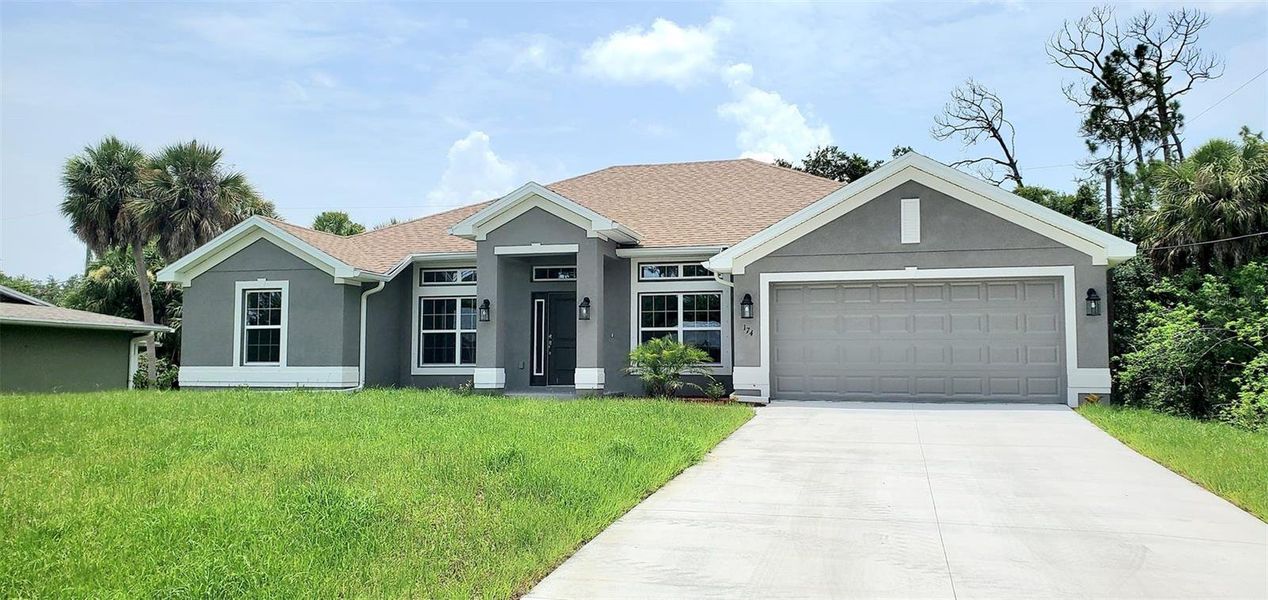 Front exterior of a new home in Port Charlotte, Port Charlotte, FL, highlighting curb appeal (Image 1). Front exterior of a new home in Port Charlotte, Port Charlotte, FL, highlighting curb appeal (Image 1).