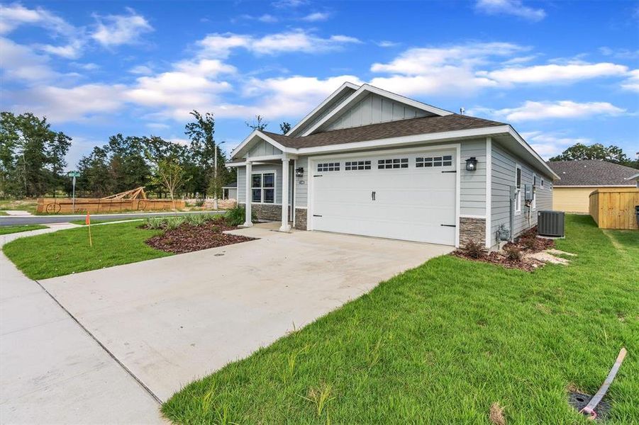 Front exterior of a new home in Grand Oaks, Gainesville, FL, highlighting curb appeal (Image 24).