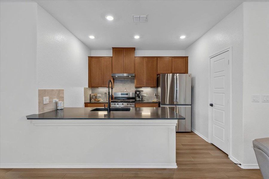 Modern kitchen with sleek countertops and rich cabinetry.
