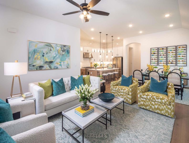 Living room with recessed lighting, arched walkways, dark wood-type flooring, and ceiling fan