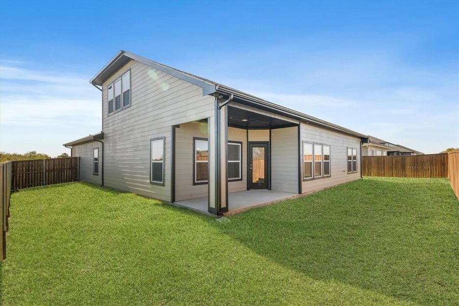 Back of property with a yard and a patio Back of property with a yard and a patio