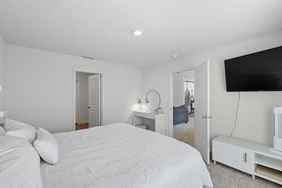 Bedroom featuring light carpet and recessed lighting