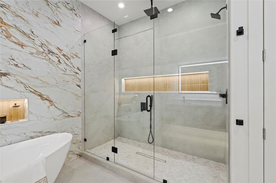 Full bath featuring a stall shower, a freestanding tub, recessed lighting, and tile walls