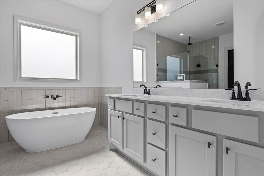 Walk-in shower with tile surround and modern fixtures.