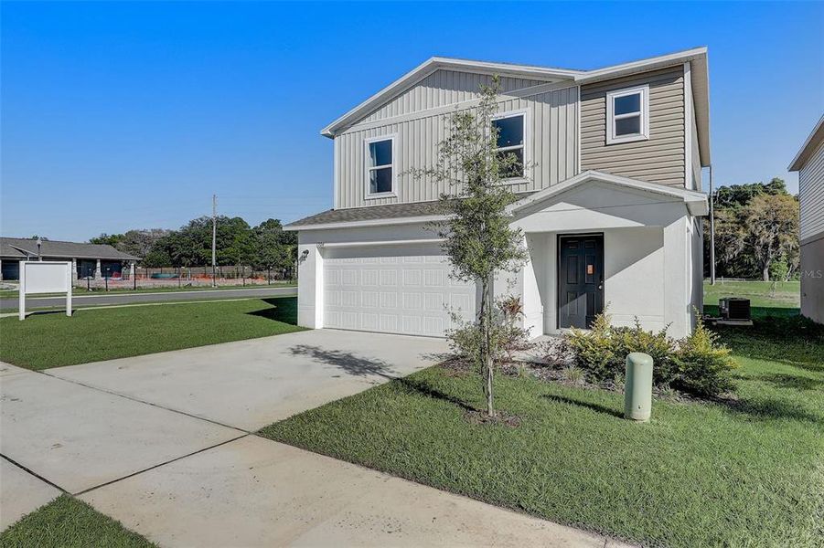 Front exterior of a new home in Bradbury Creek, Haines City, FL, highlighting curb appeal (Image 23). Front exterior of a new home in Bradbury Creek, Haines City, FL, highlighting curb appeal (Image 23).