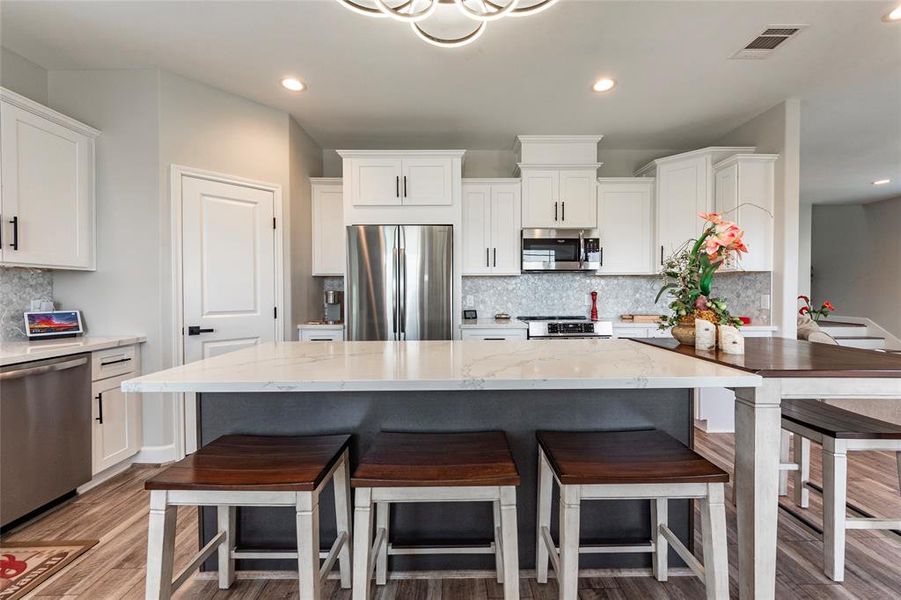 The heart of the home, this kitchen boasts a large island with ample seating, perfect for meal prep or casual gatherings.