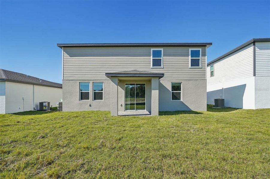 Exterior details and patio area of a home in The Reserve at Hammock Oaks - Signature Series, Lady Lake (Image 3).