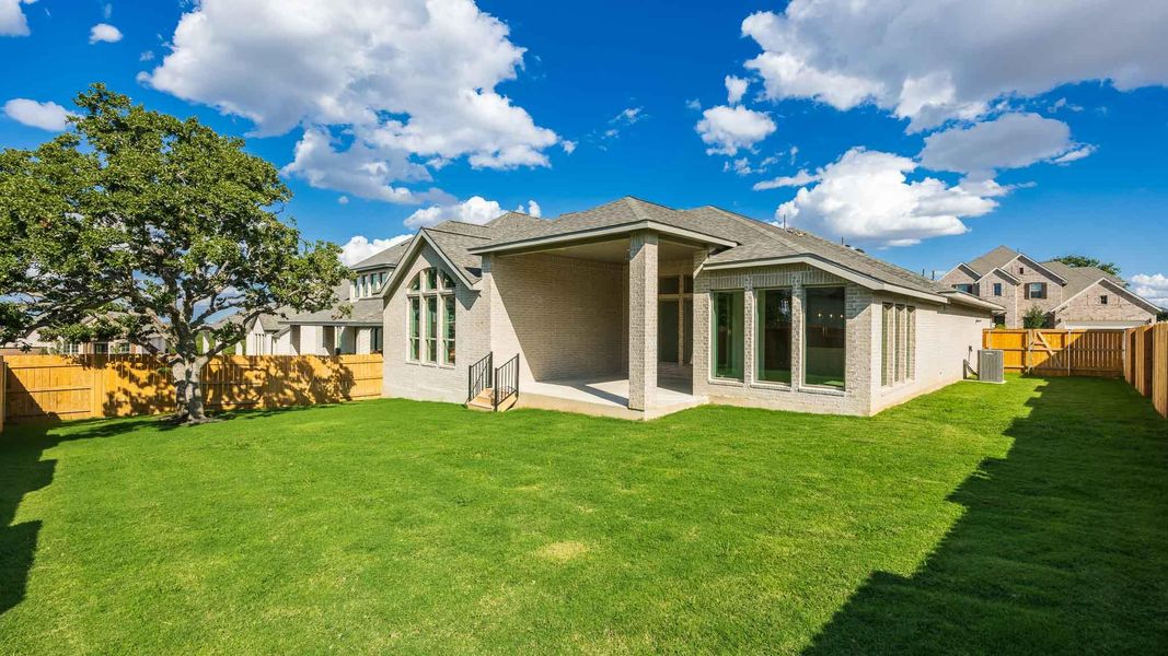 Back of house featuring a patio, a fenced backyard, brick siding, and a shingled roof Back of house featuring a patio, a fenced backyard, brick siding, and a shingled roof
