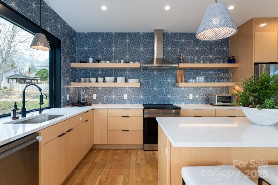 Floating shelves and a decorative backsplash define the space Floating shelves and a decorative backsplash define the space