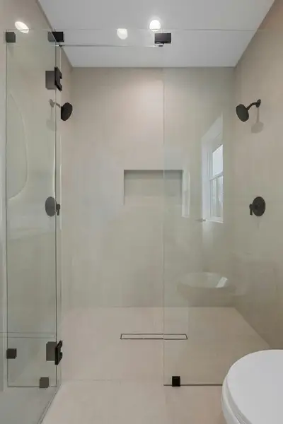 Bathroom featuring a shower stall, tile patterned floors, and recessed lighting