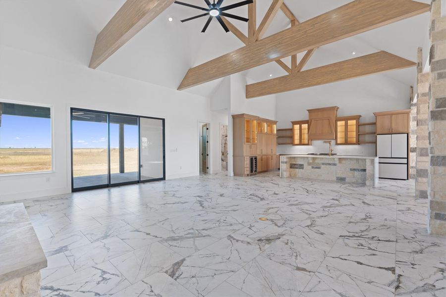 Vast open-concept living space with vaulted ceilings and a well-appointed kitchen island, perfect for entertaining. Vast open-concept living space with vaulted ceilings and a well-appointed kitchen island, perfect for entertaining.