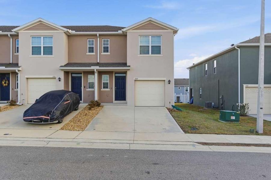 Front exterior of a new home in Brentwood, Davenport, FL, highlighting curb appeal (Image 26).