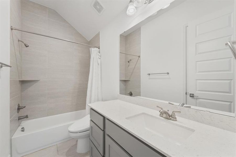 Guest En Suite - showers are tile all the way to the ceiling in all 3 bathrooms.