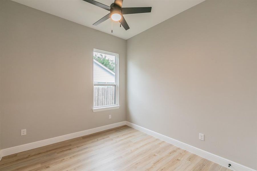 Unfurnished room with light wood-style flooring, baseboards, and ceiling fan Unfurnished room with light wood-style flooring, baseboards, and ceiling fan